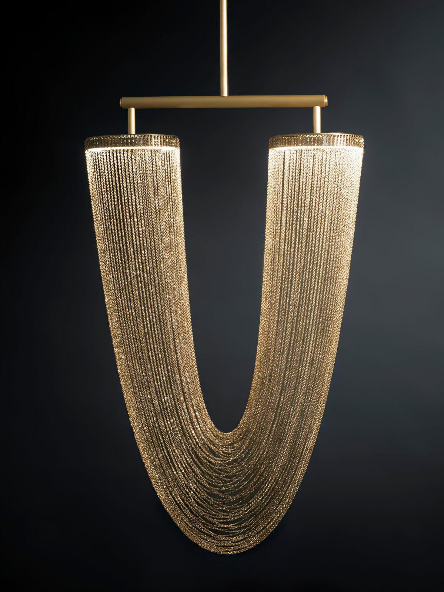 Copper-coloured chain chandelier with two illuminated rings and nested hanging curves