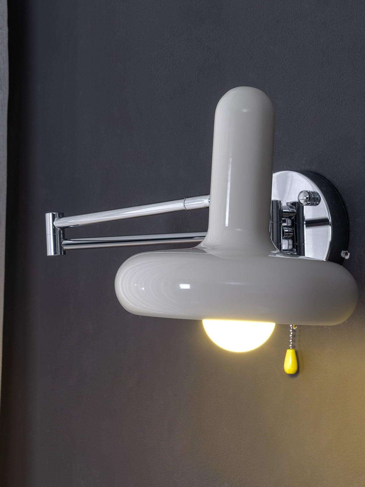 Lit cream wall shade against dark wall with hanging pull