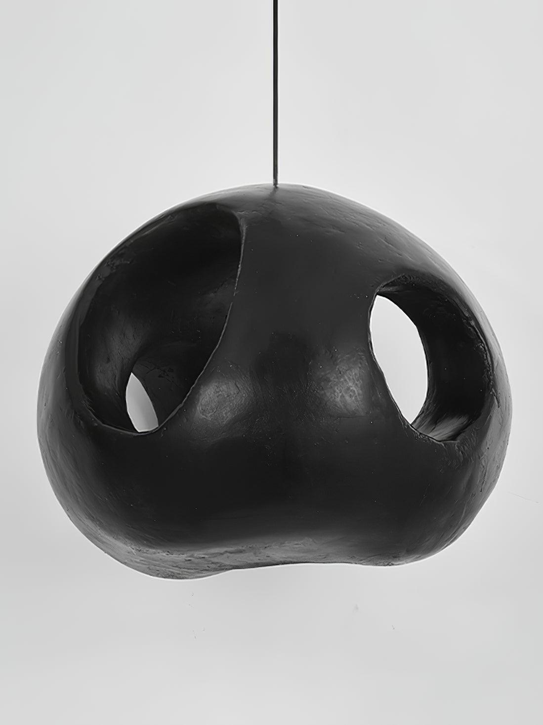 Unlit black shade showing its irregular rounded profile