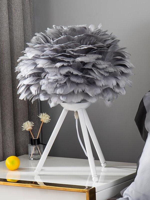 Grey feather shade on white tripod