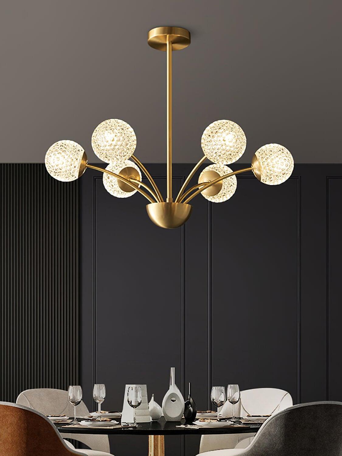 Textured globe chandelier above a dining table with stemmed glasses, mixed chairs and dark wall panels