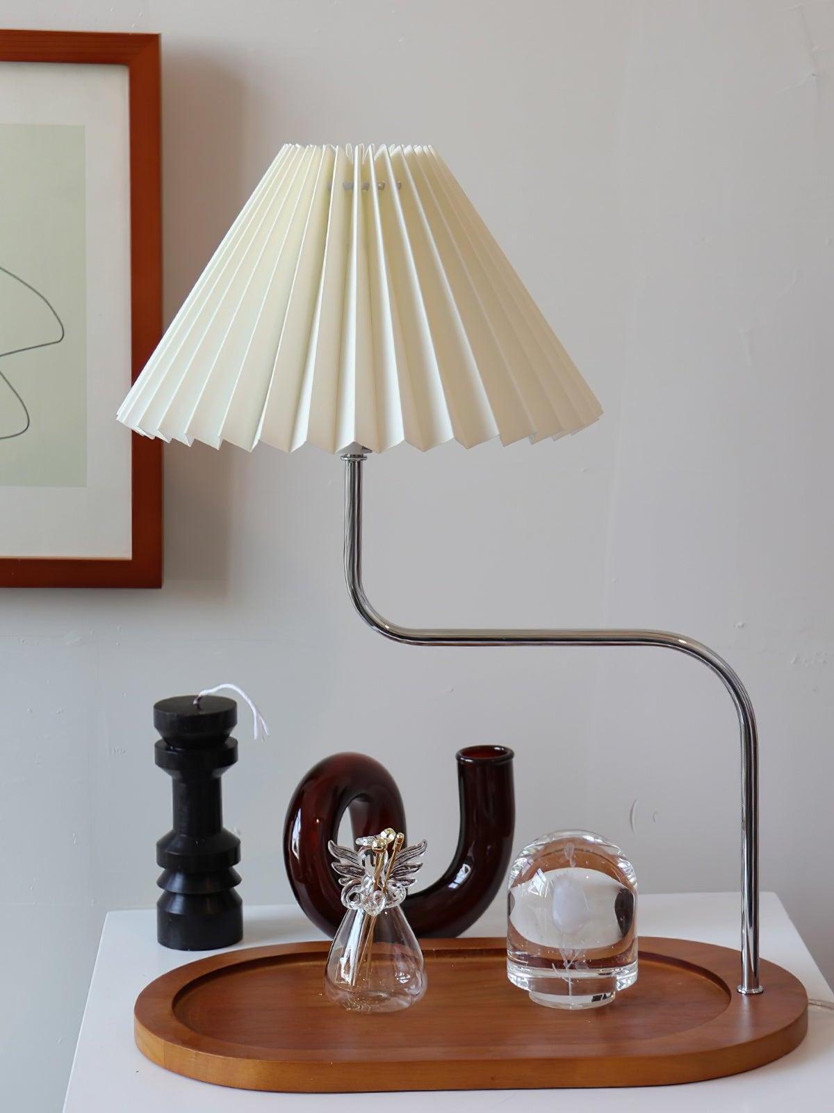 Beige pleated lamp on elongated wooden tray