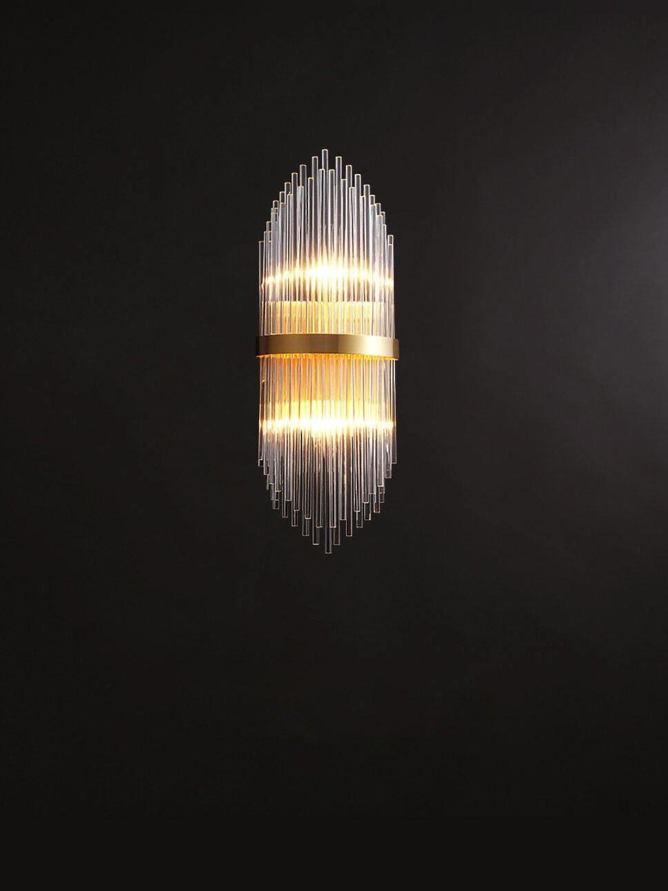 Warmly lit crystal rod sconce with upper and lower light bands