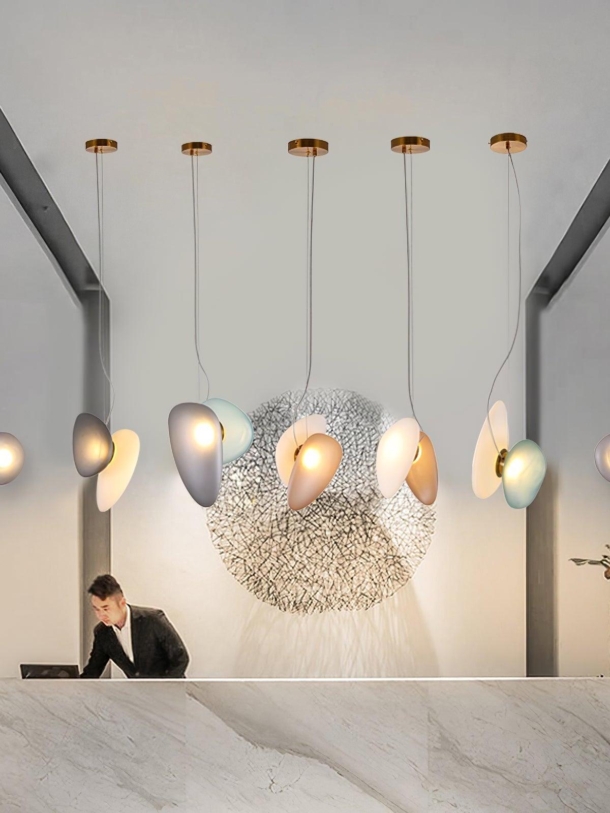 Several separate pebble pendants over a reception desk