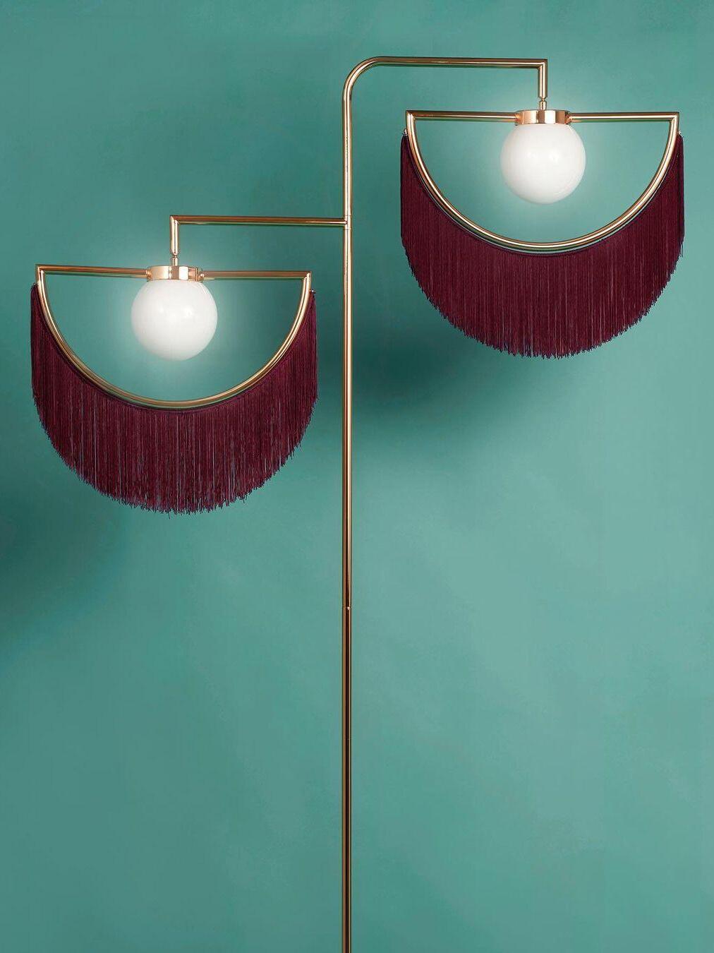 Wink maroon fringes and white glass globes close-up