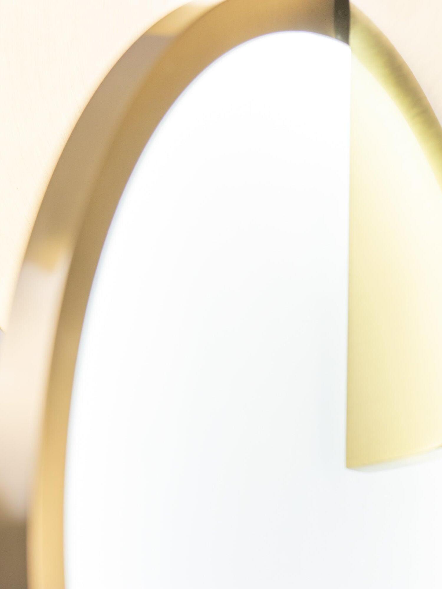 Extreme close view of a gold rim overlapping the white acrylic diffuser