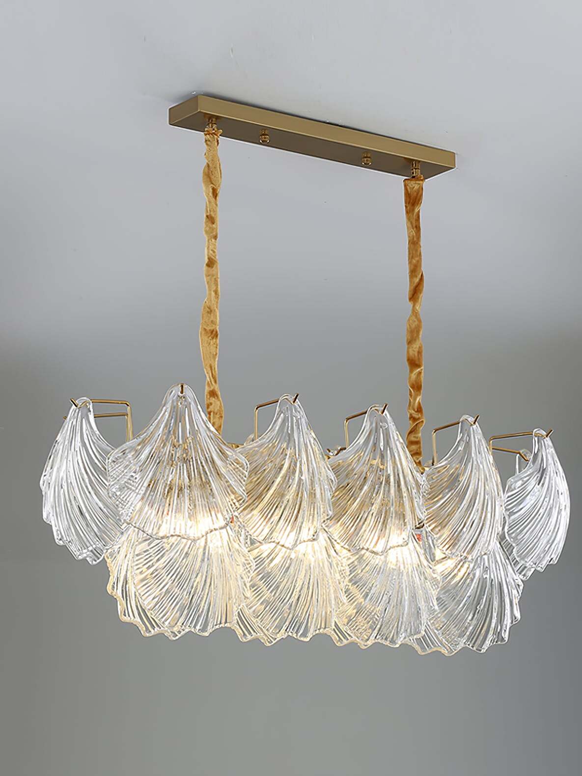 Oblong shell-panel fixture with two fabric-covered suspension drops and a long rectangular canopy