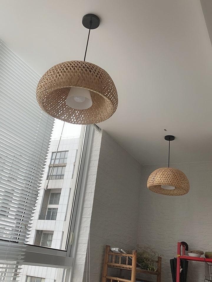 Two woven pendant shades near sloped window
