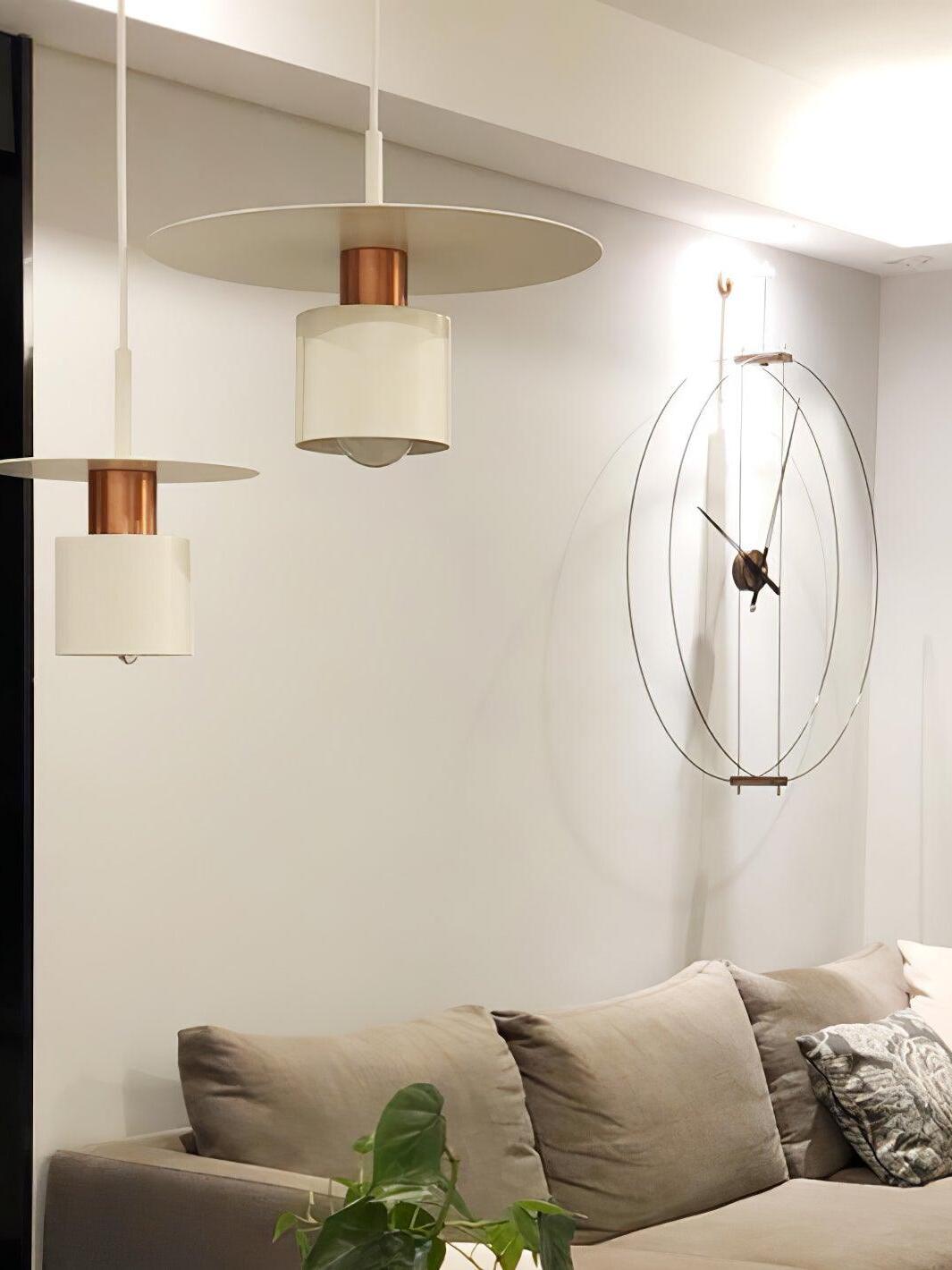White disc pendants near living room sofa