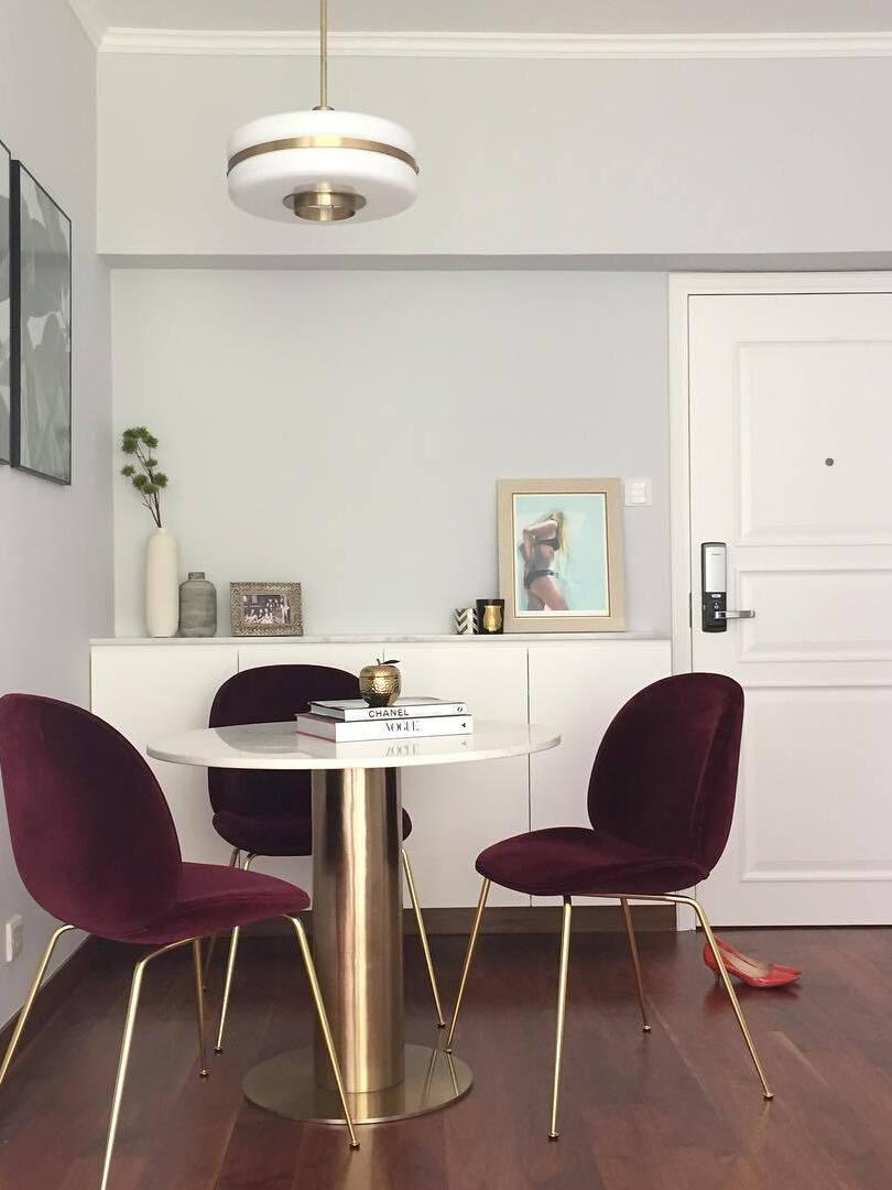Masina pendant in a dining nook with dark chairs