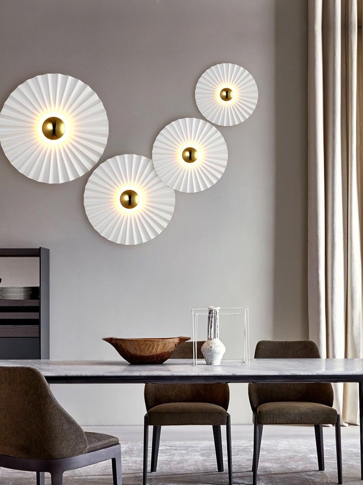 Three radial wall lights above dining table