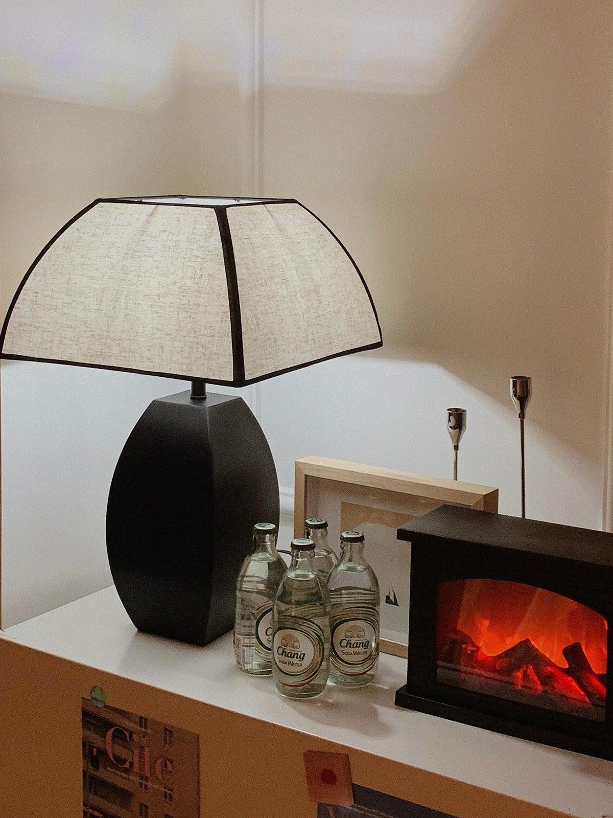 Lit Javier lamp on shelf beside fireplace