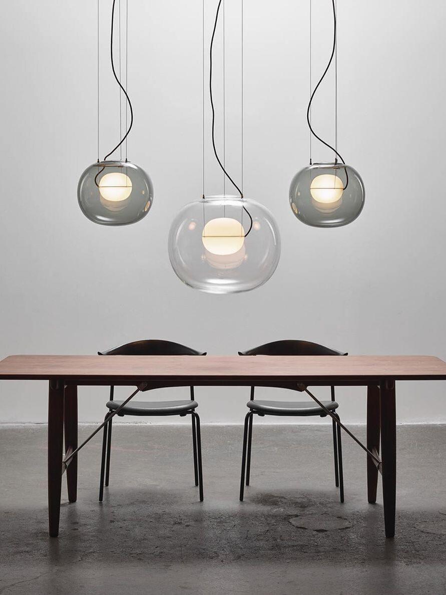 Three suspended glass globes above a rectangular table