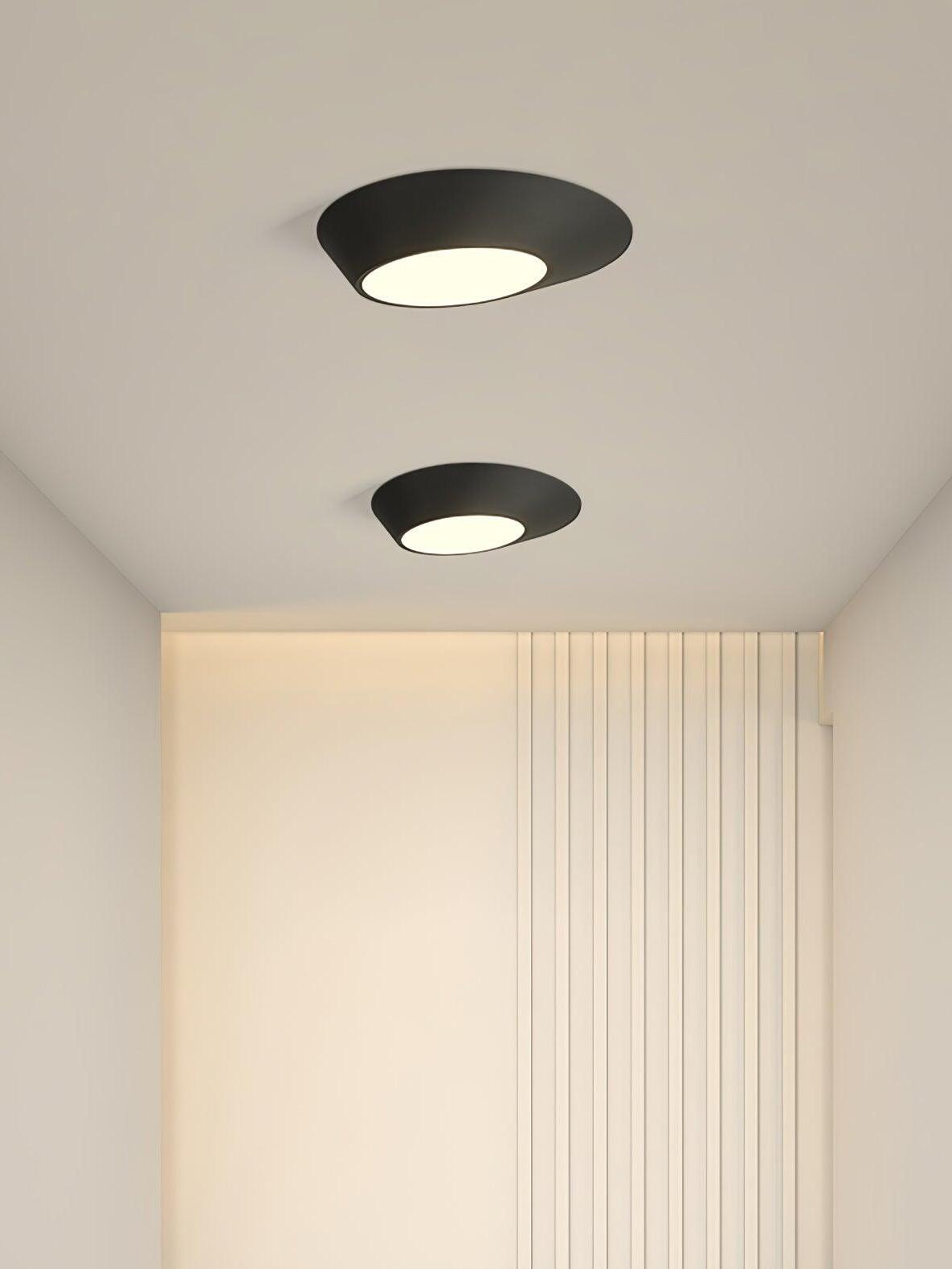 Two glowing black angled ceiling lights above vertical white wall slats