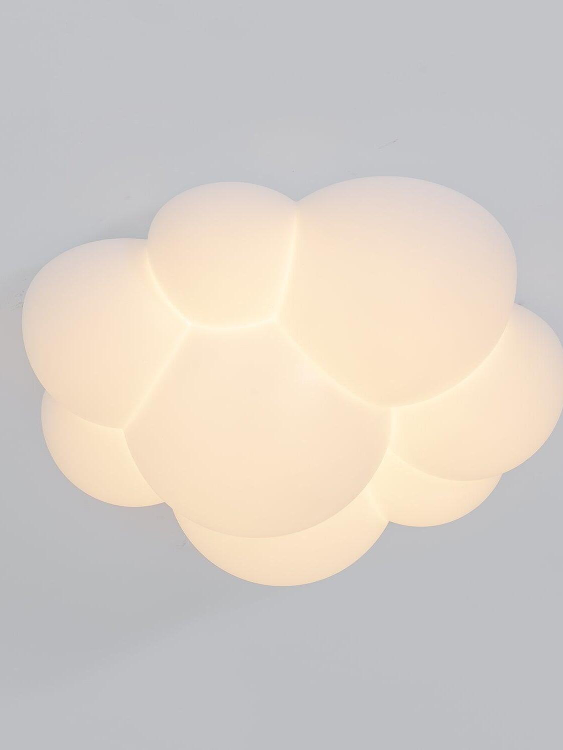 Angled underside view of the glowing rounded lobes of a Nuage ceiling light