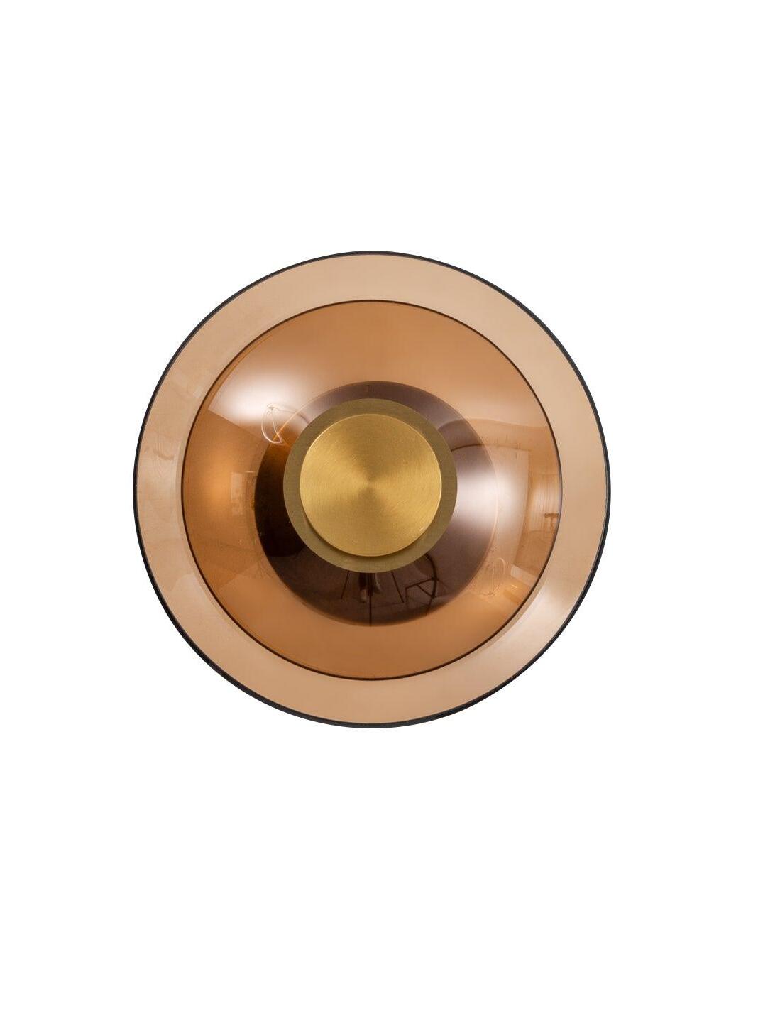Amber glass disc and gold fitting on white background