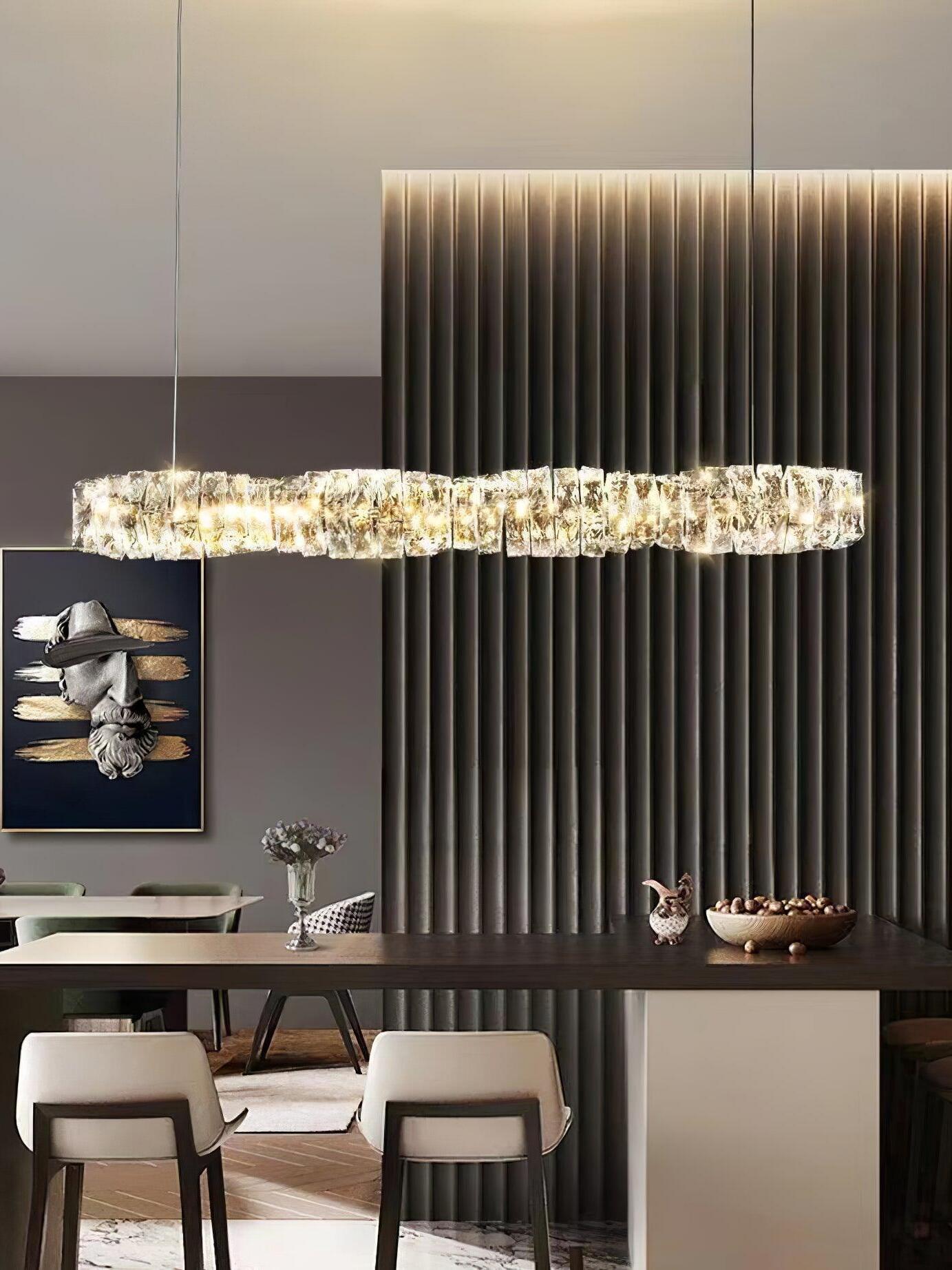 Warm-looking crystal bar above a dining table in front of a vertically ribbed illuminated wall