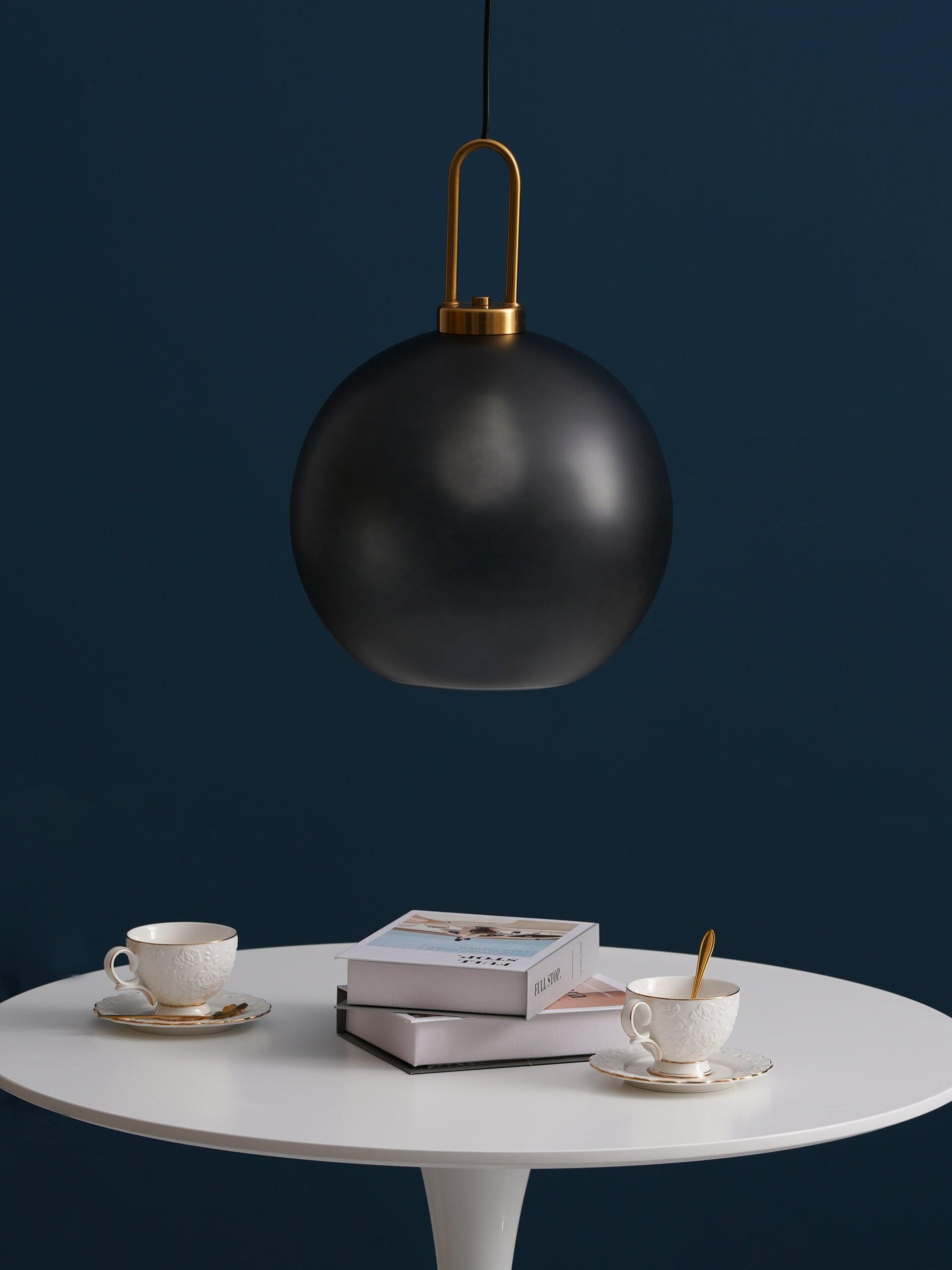 Smoky globe pendant above books and cups
