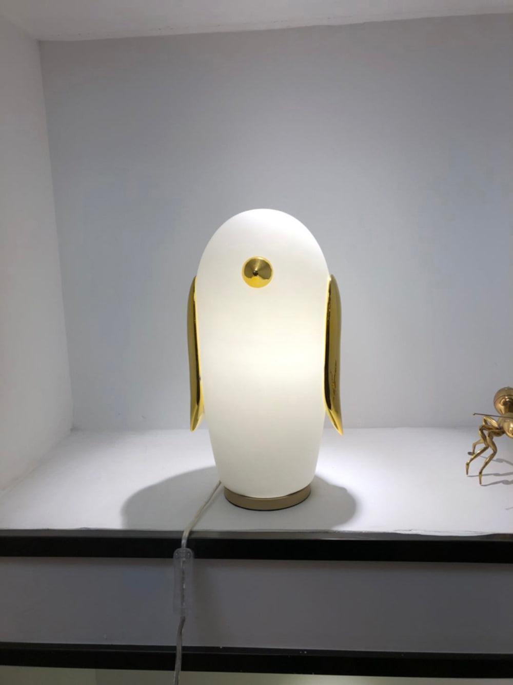 Tall white penguin on narrow window ledge with white cord and inline control