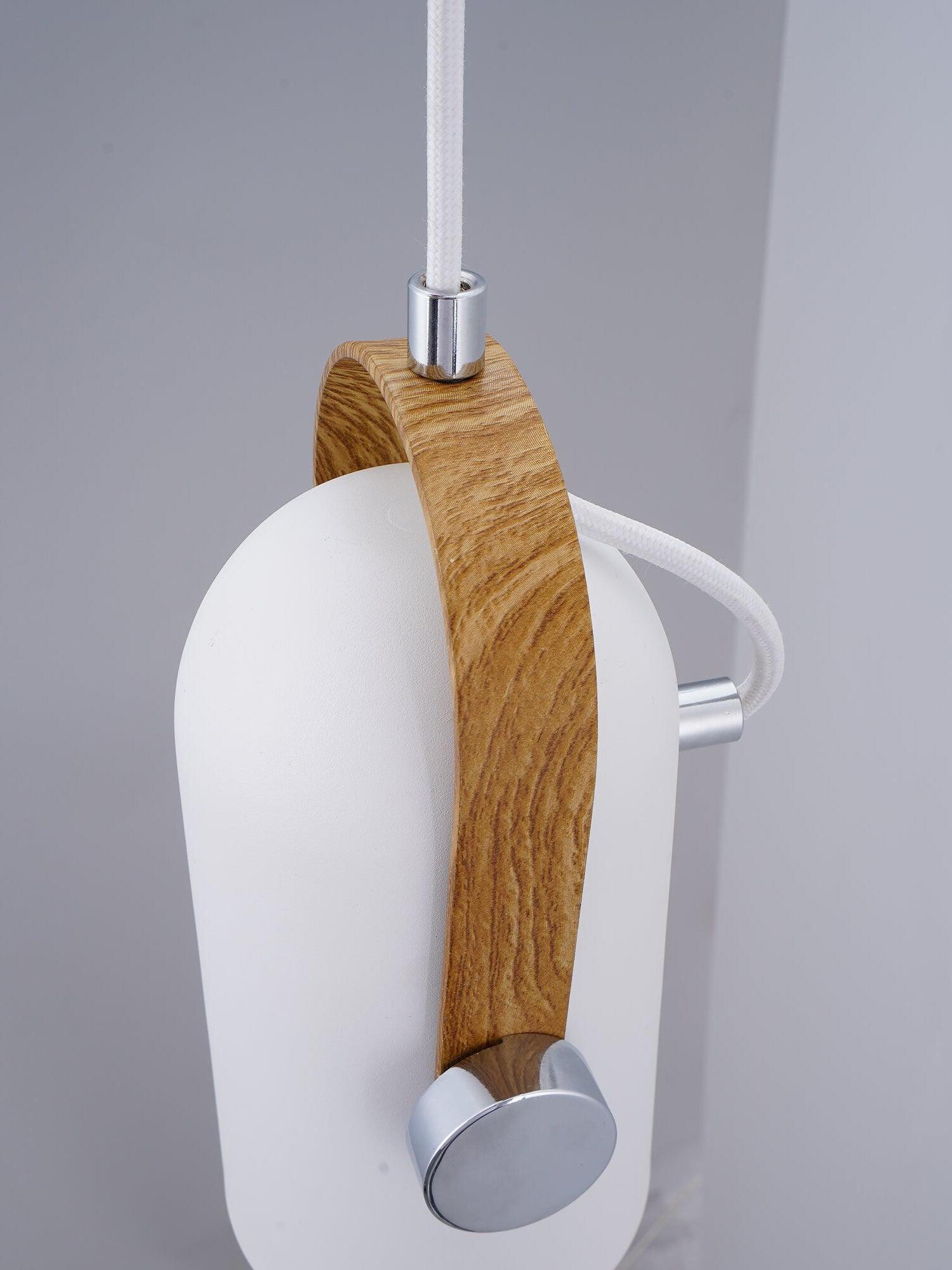 Side detail of white head, curved light wood bracket, silver-tone pivot and white cable loop