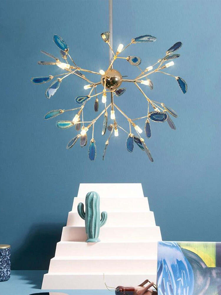Blue stone-slice radial chandelier against a blue wall