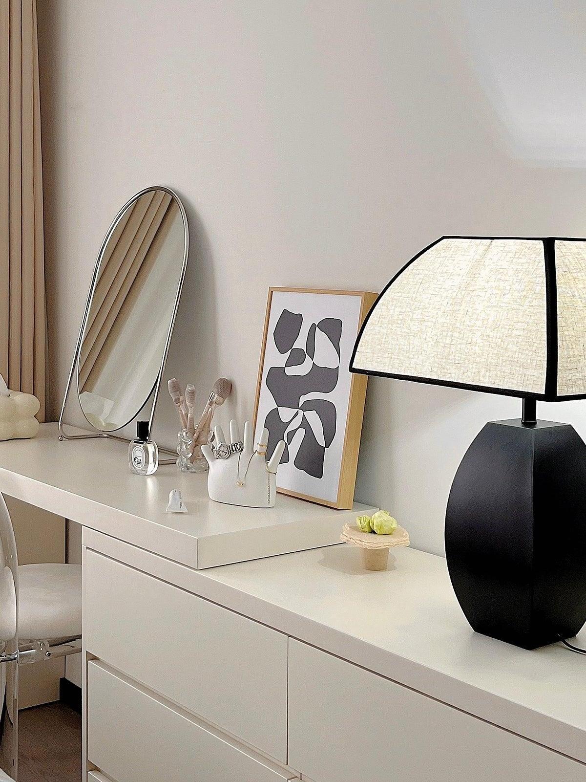 Black Javier lamp on white dresser beside mirror
