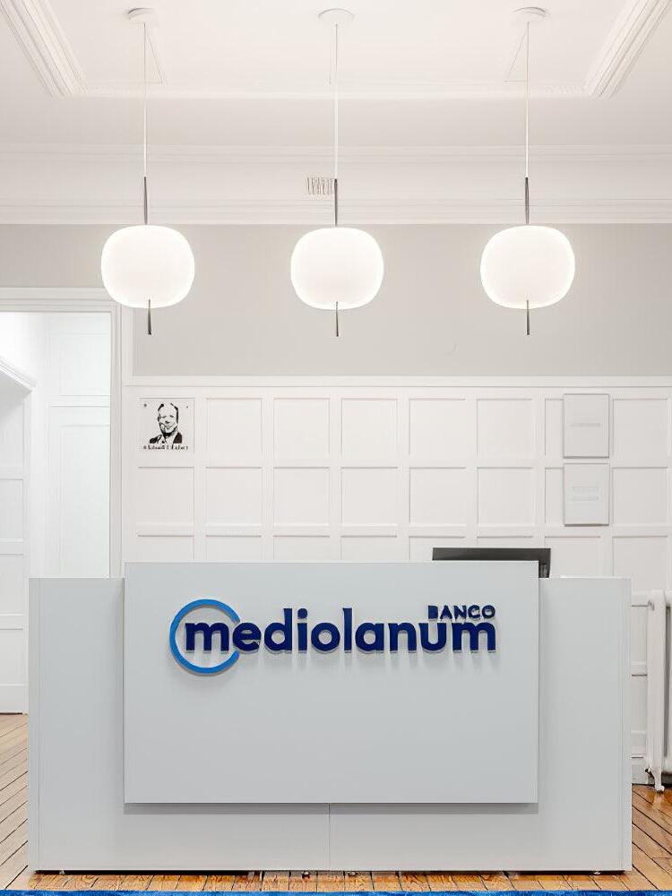 Three white pendants above a reception desk