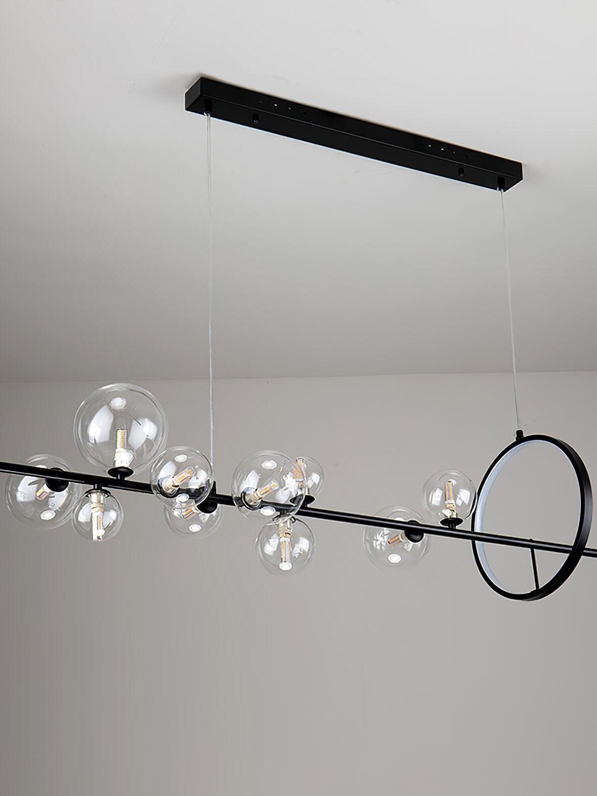 Angled view of a linear globe chandelier and bar canopy