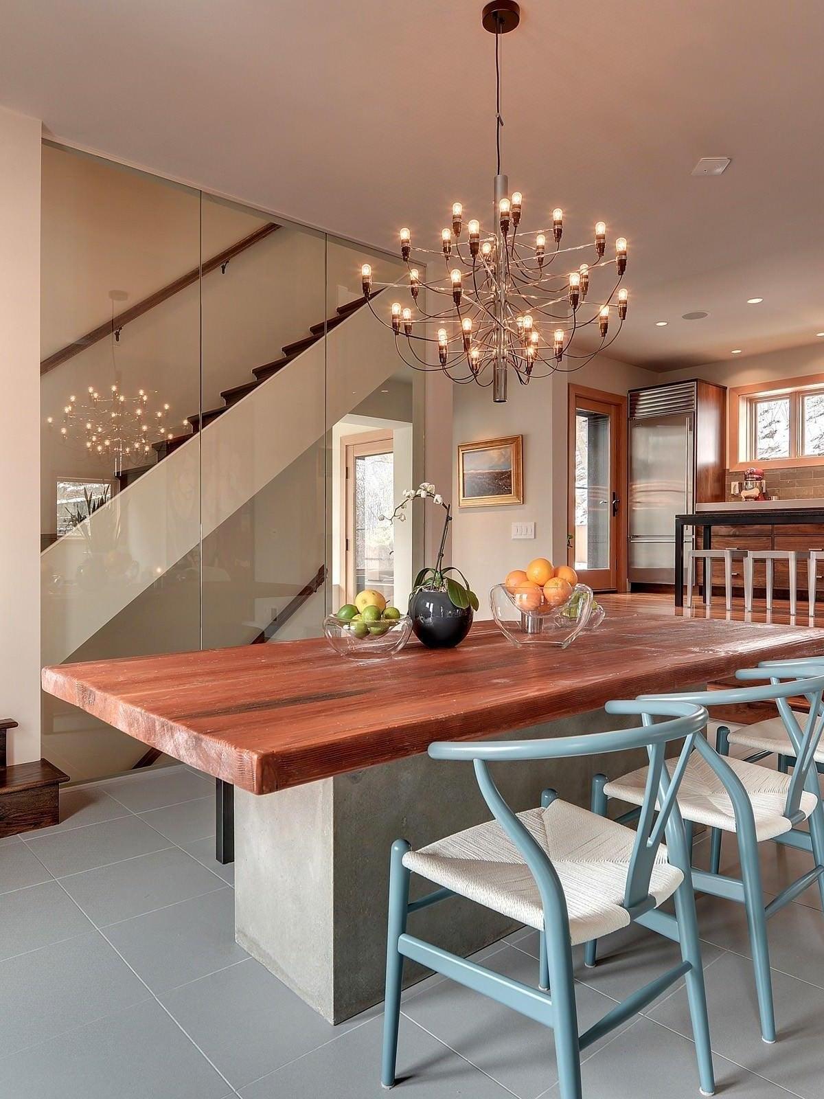 Chandelier above a dining table near stairs