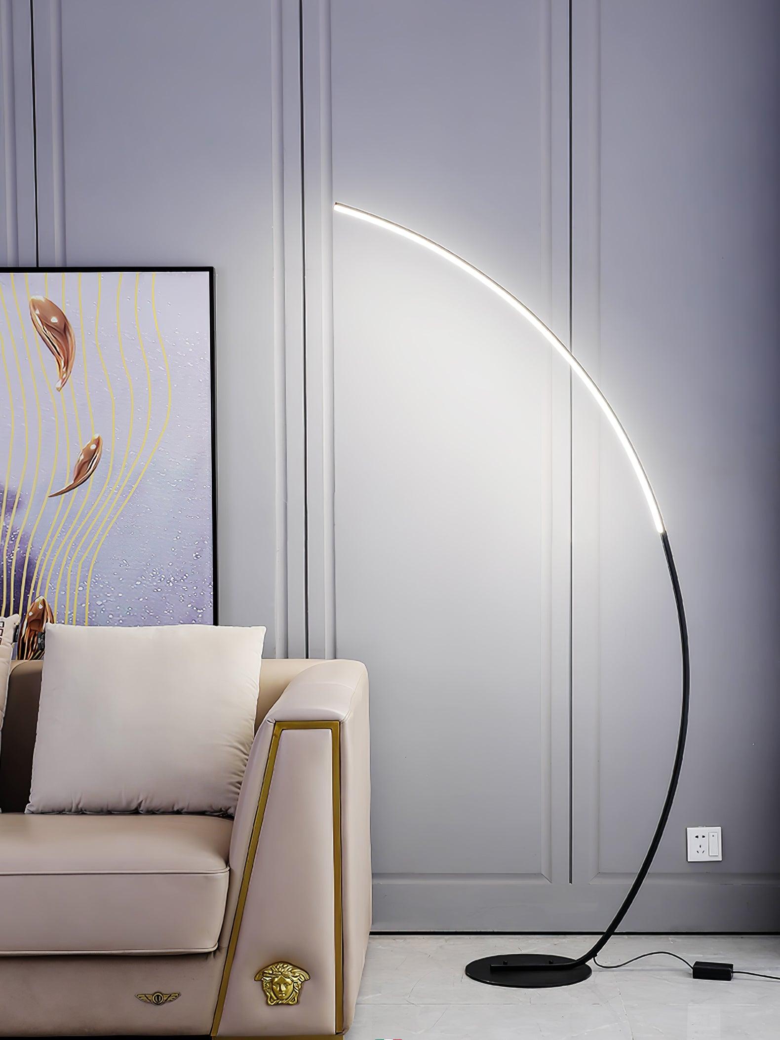 Black illuminated arc behind pale sofa