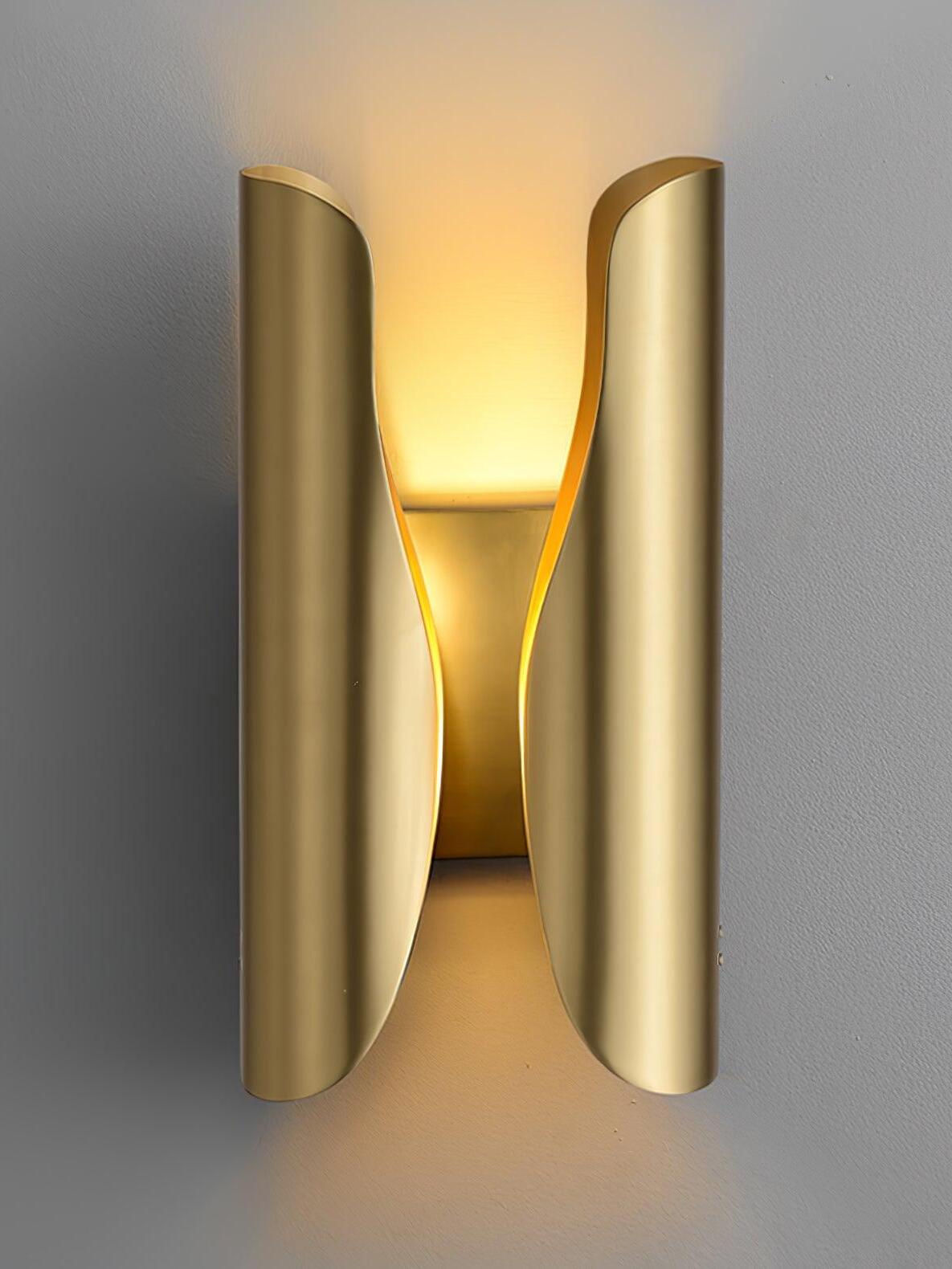 Brushed brass Guardian wall sconce with tall curved wings and light above and below