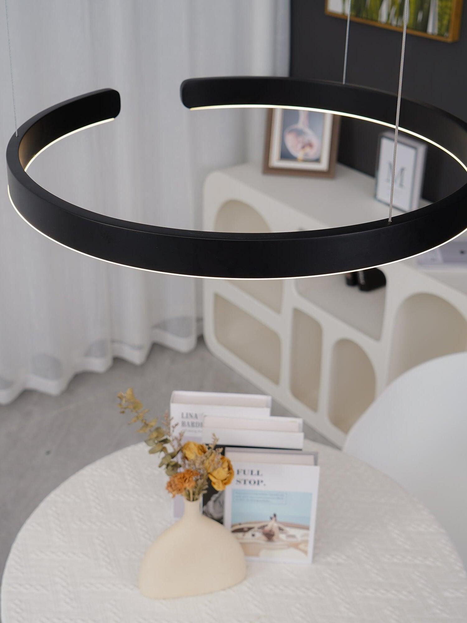 Black open ring above a white dining table