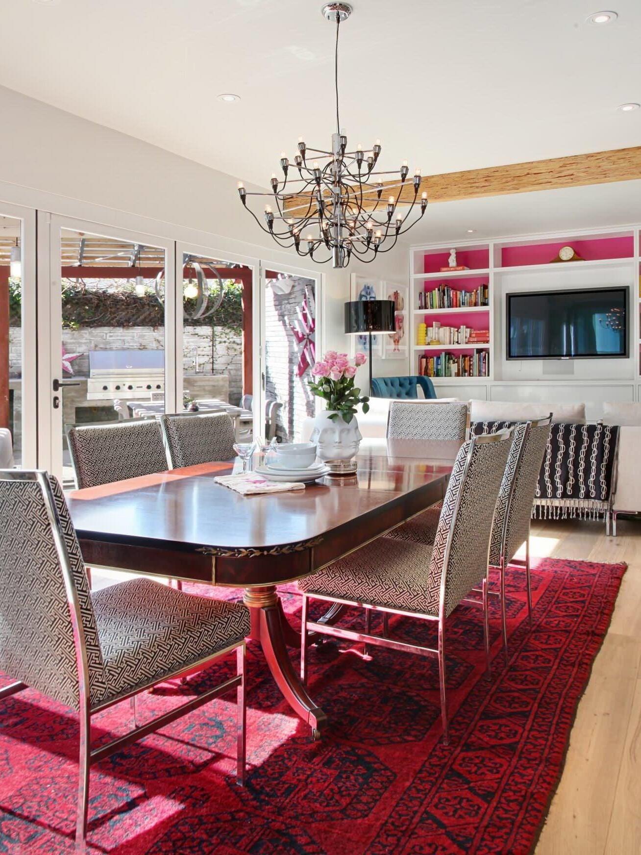 Looped-wire chandelier over a table and red rug