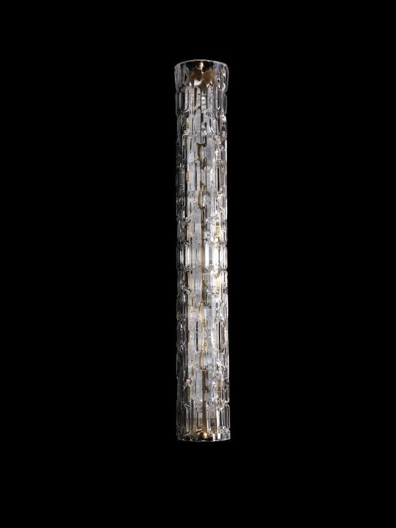 Taller clear textured glass wall light on black background