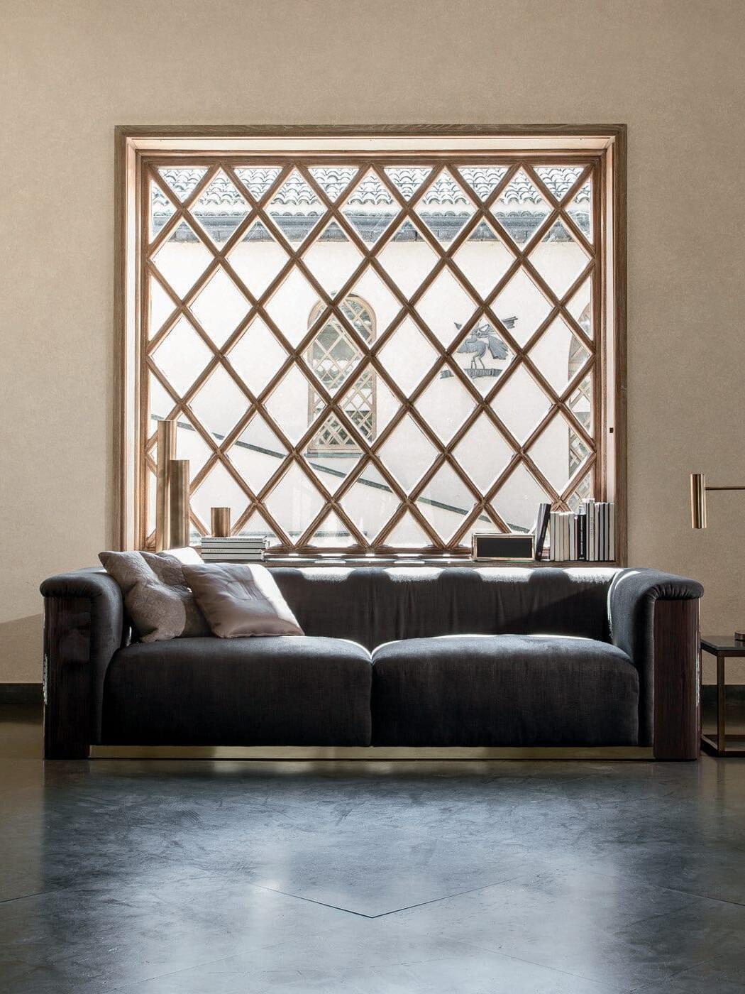 Wide sofa room with lattice window and slim gold-tone lamp on side table