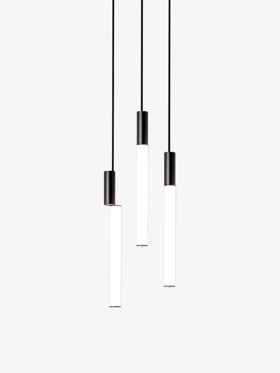 Three black-top white luminous pendants at staggered heights