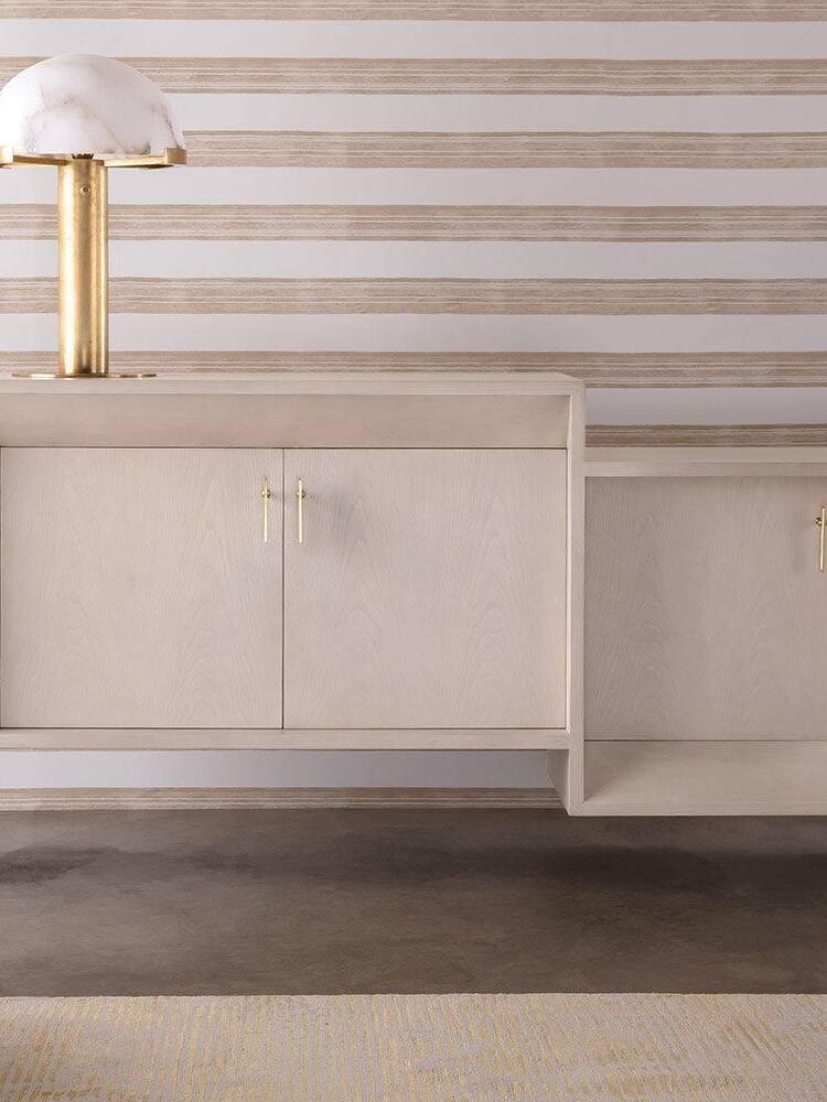 Gold lamp above a pale cabinet