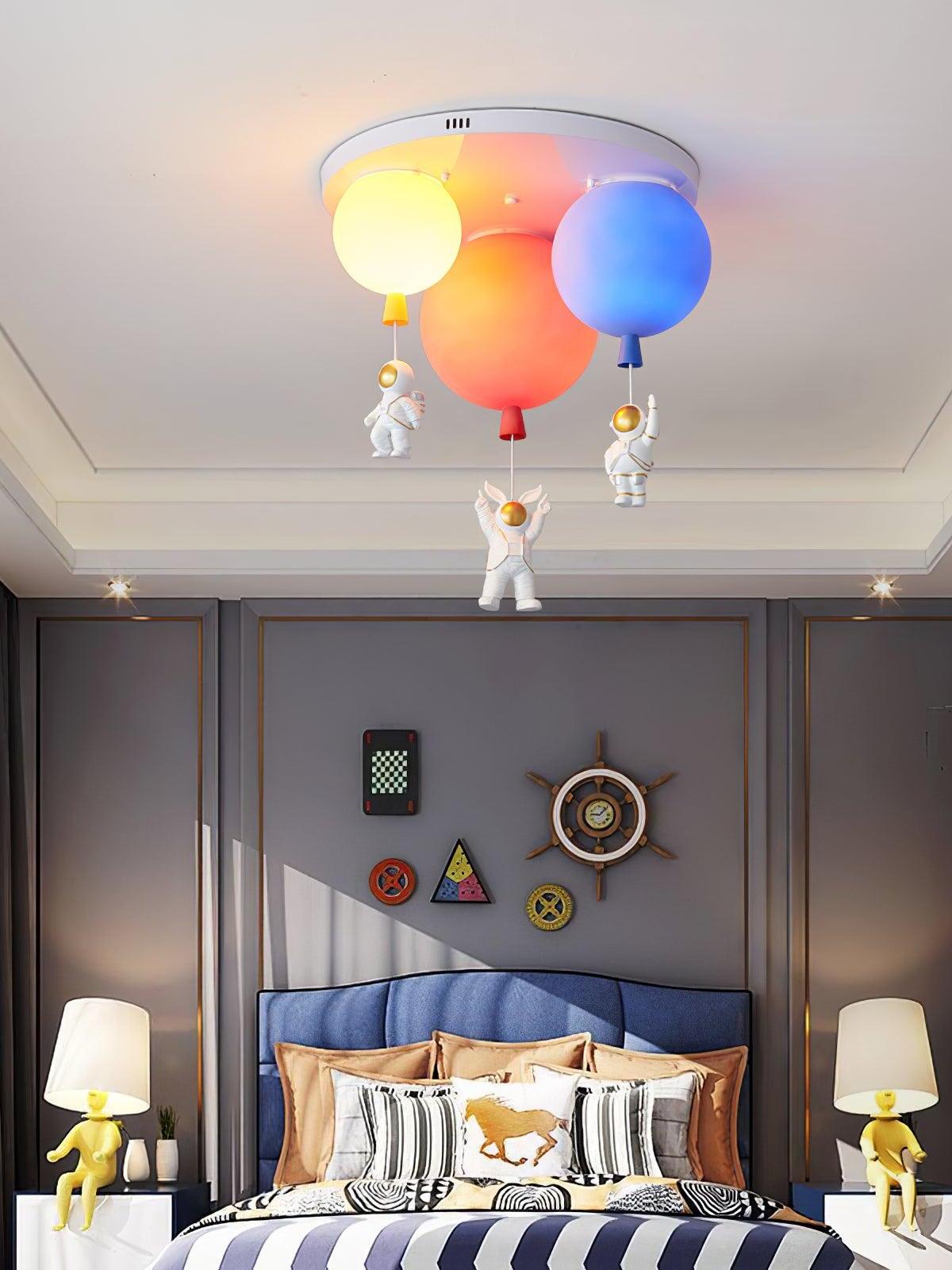 Balloon ceiling light above a blue upholstered bed