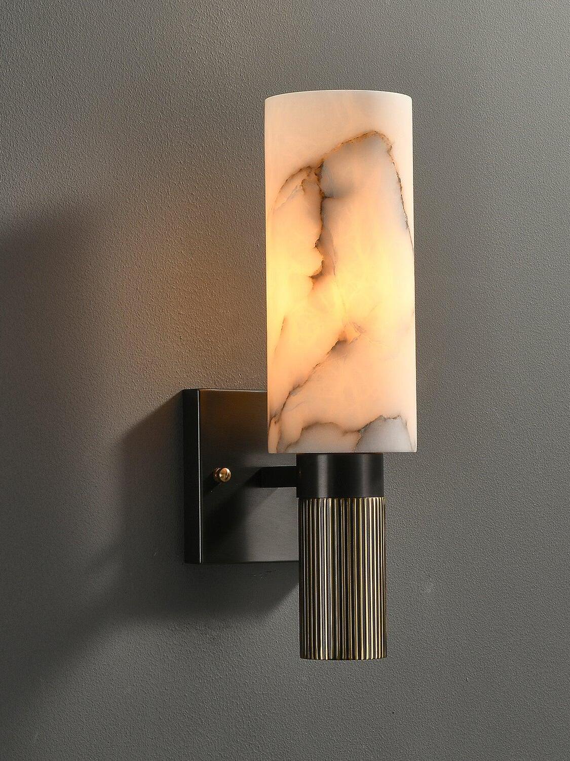 Lit white marble sconce with rectangular black backplate