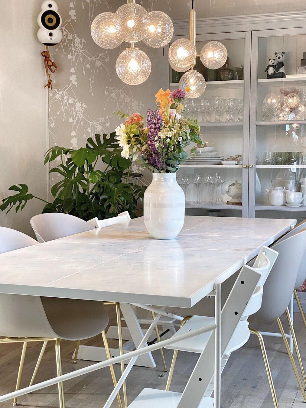 Clear glass cluster above a table with flowers