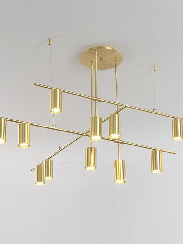 Gold-coloured chandelier beneath a round ceiling canopy