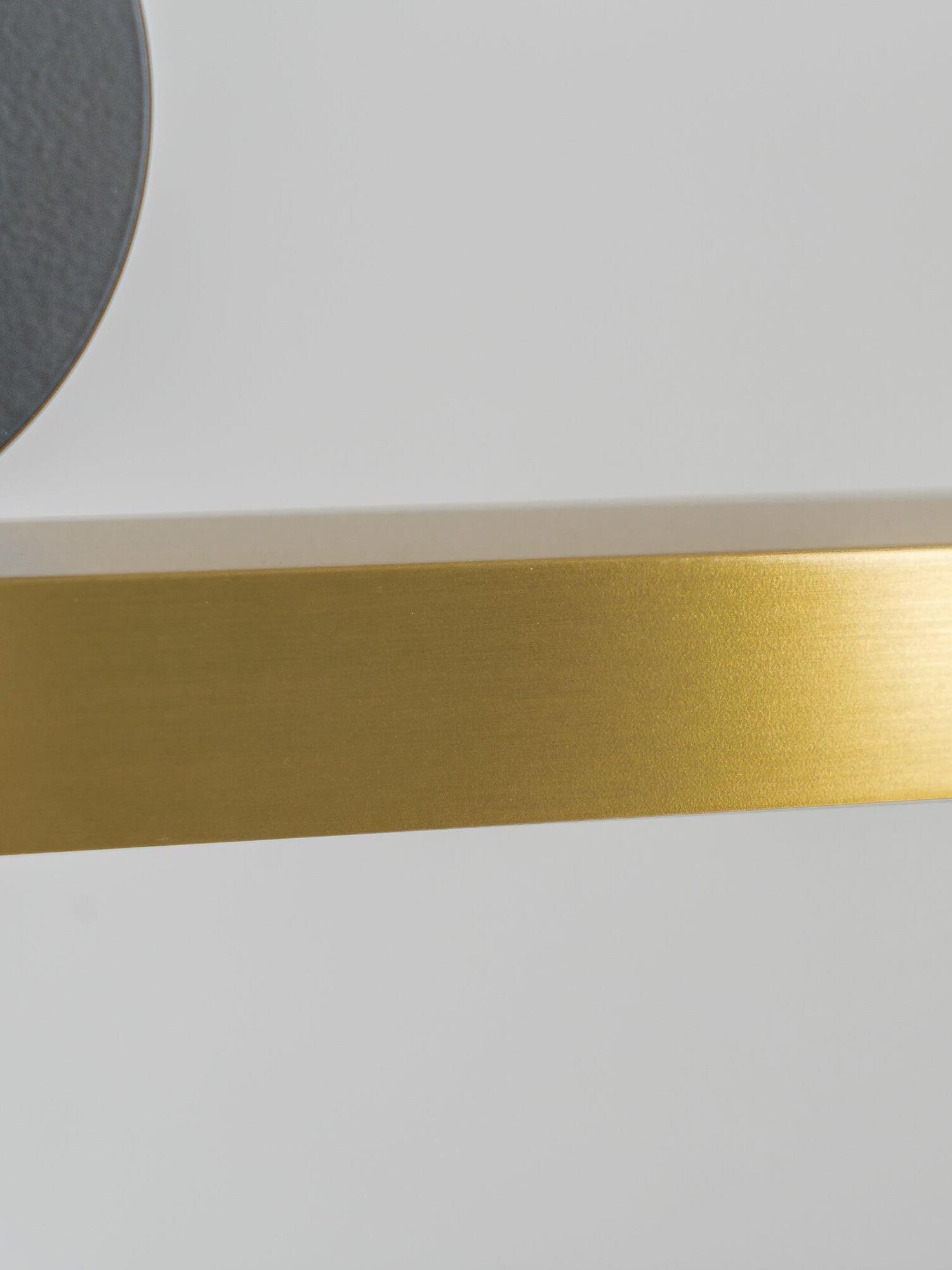 Gold-toned bar surface beside Black disc