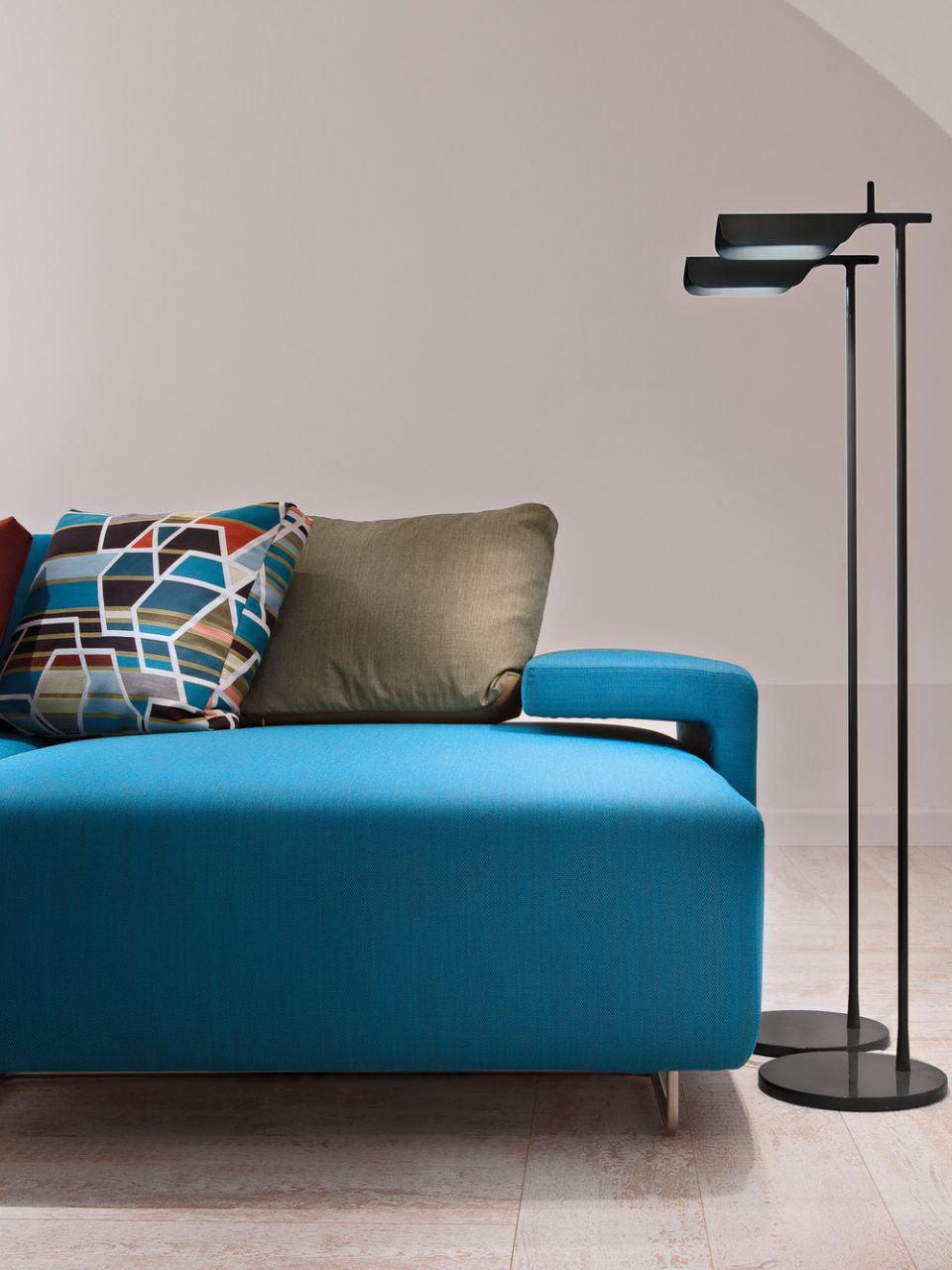 Black floor lamp beside a blue sofa