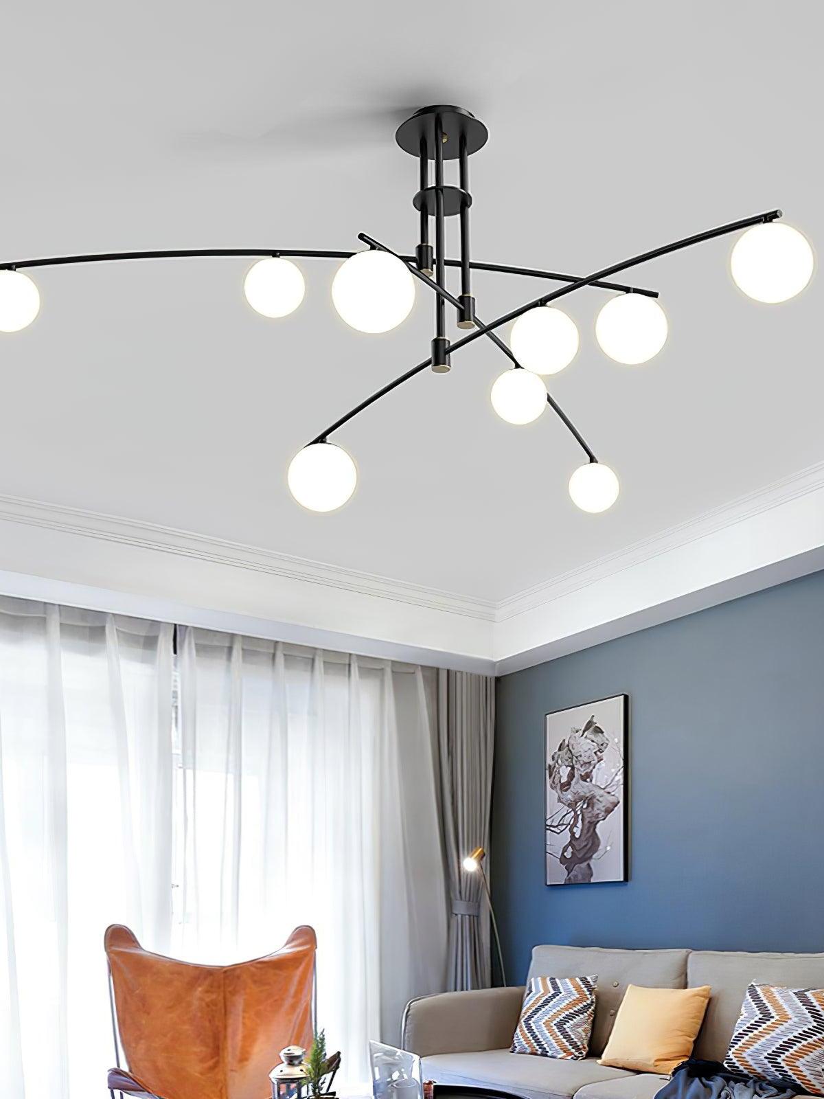 Black Long Arm chandelier above a sofa