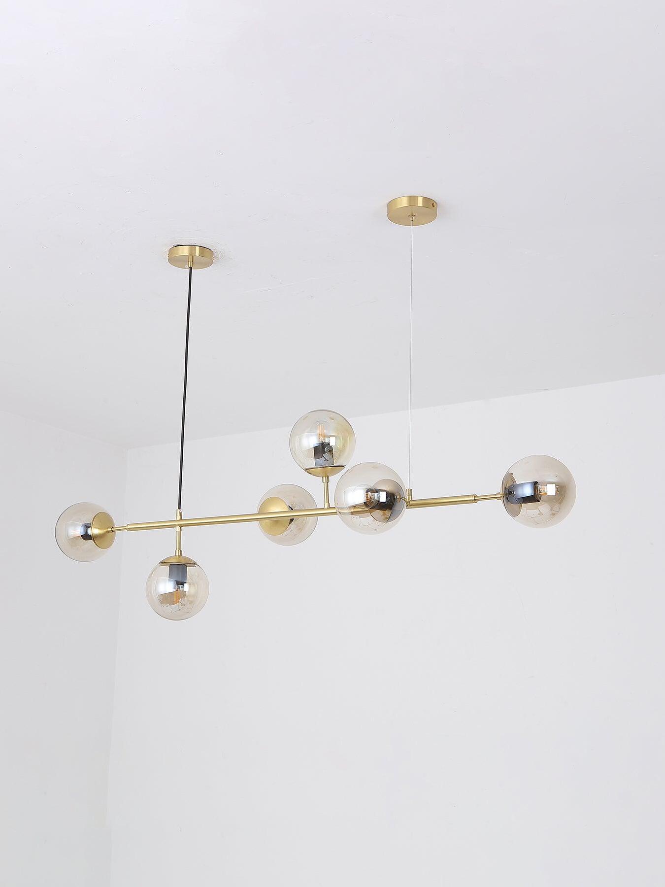Round glass globes projecting around a straight bar