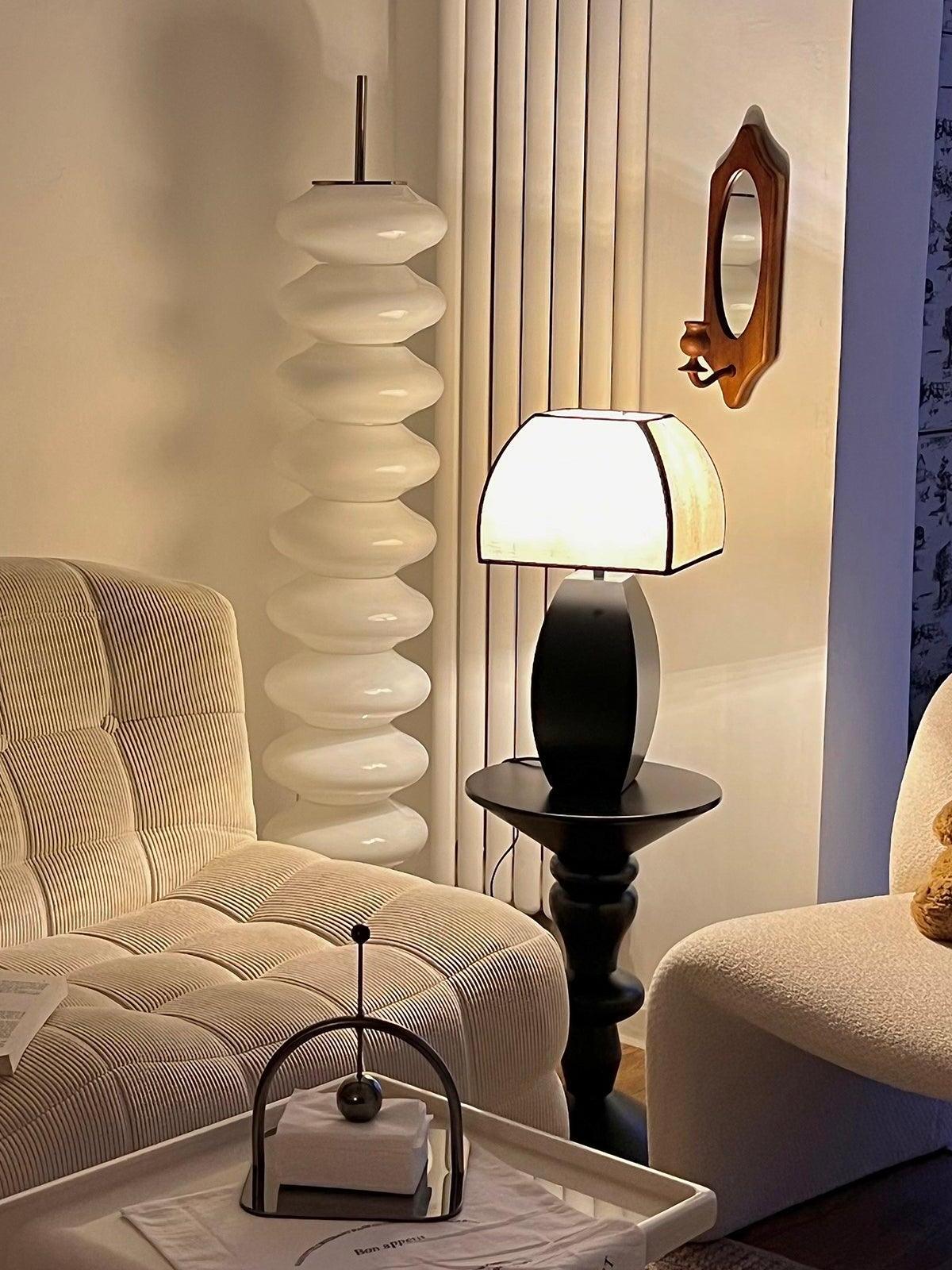 Lit Javier lamp between pale armchairs