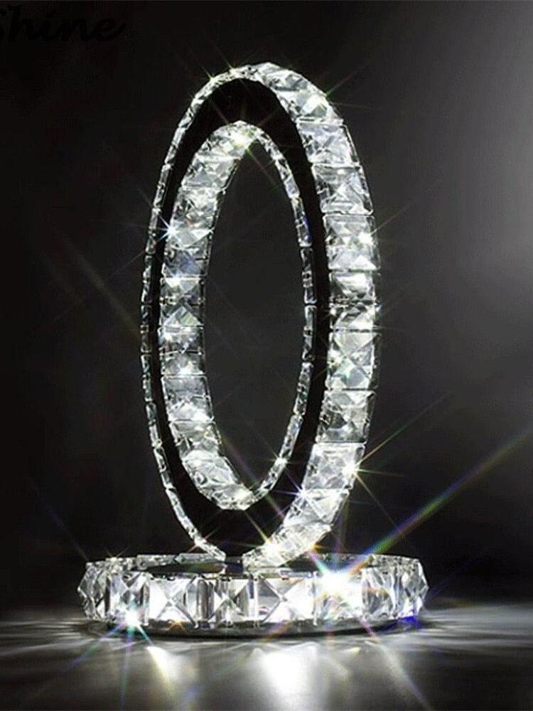 Angled illuminated ring lamp with bright reflections around the round base