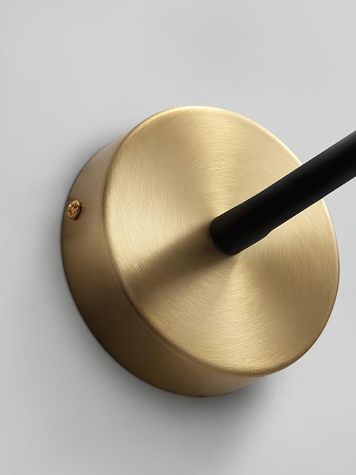 Close gold Flexi round wall plate with brushed-looking surface, dark arm entry and a visible side screw