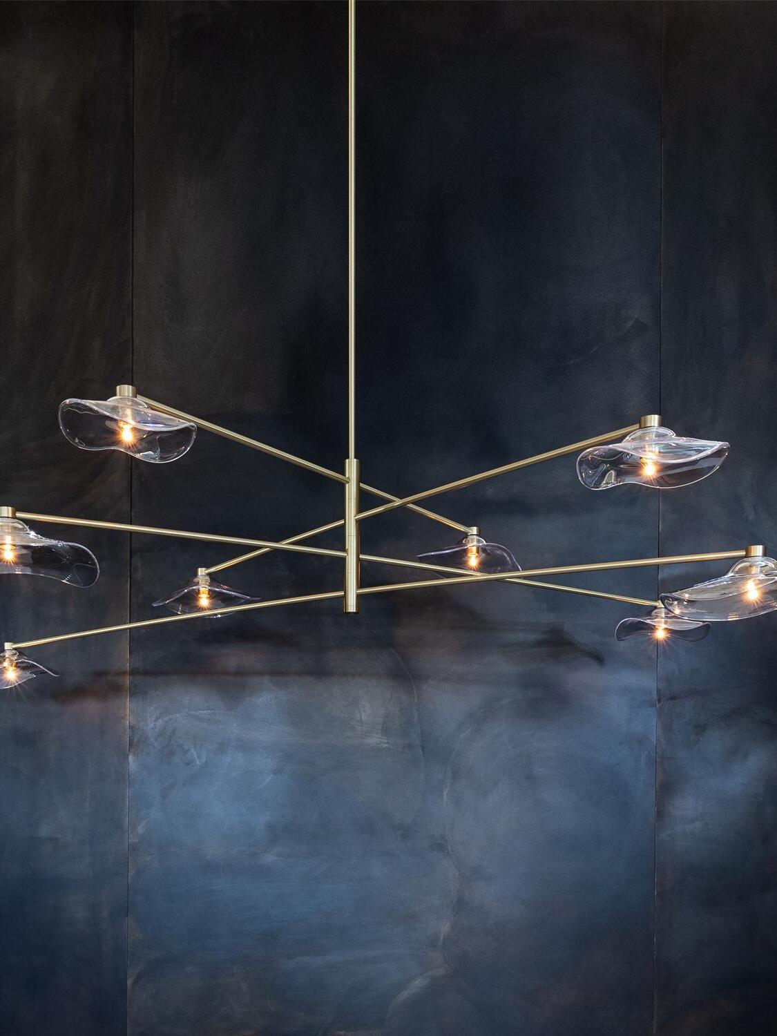 Gold tiered arms and illuminated glass shades