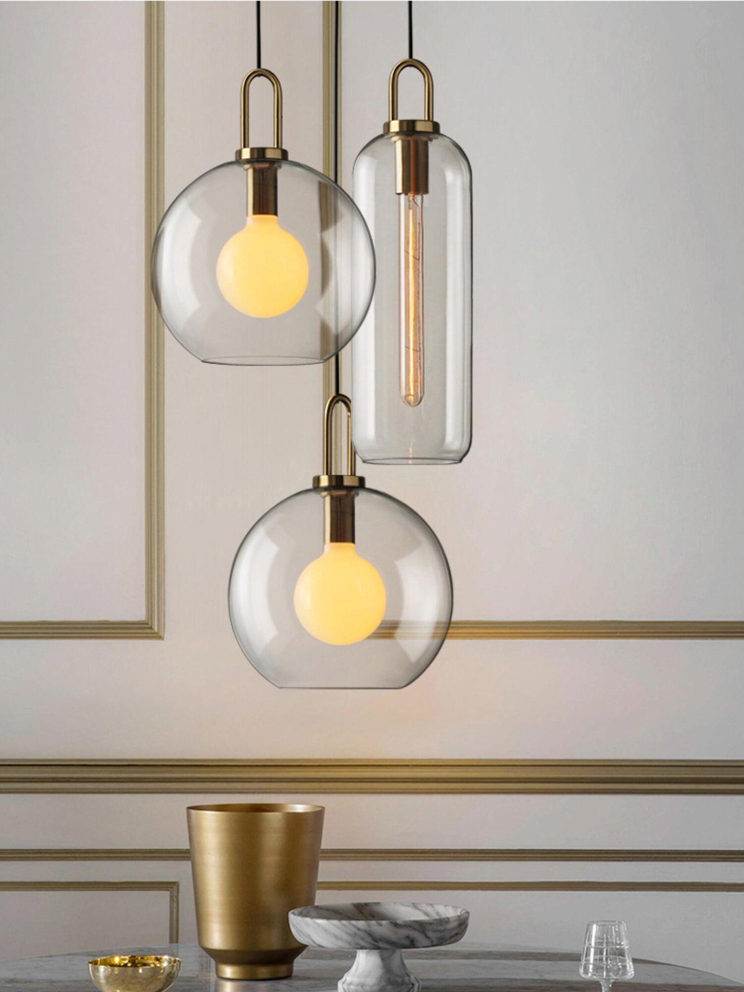 Clear capsule and sphere pendants hanging together